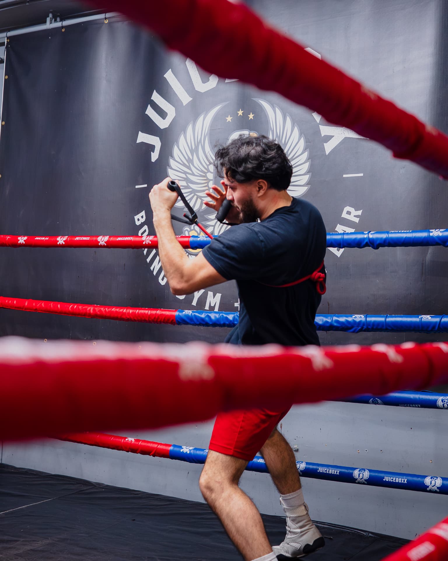Boxer shadow training inside the ring at a local boxing gym