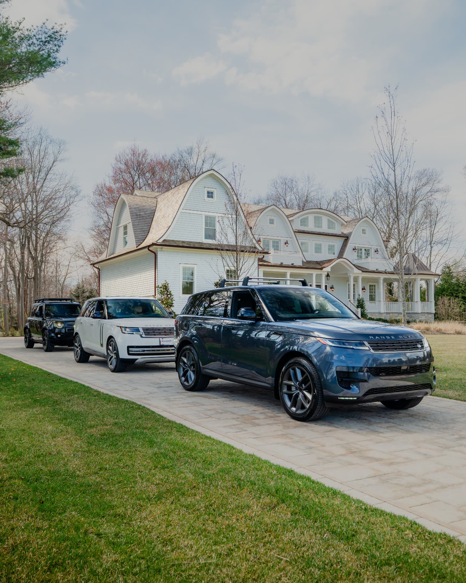 Range Rover lineup in the driveway of a luxury New Jersey home