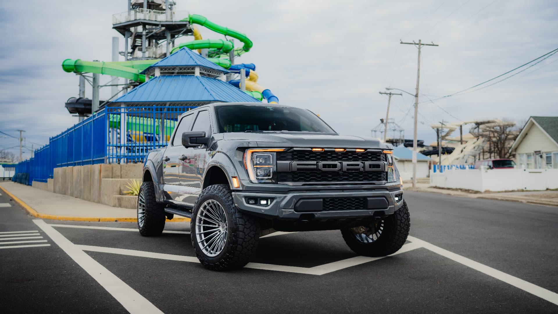 Dark grey Ford F-150 Raptor parked at a water park